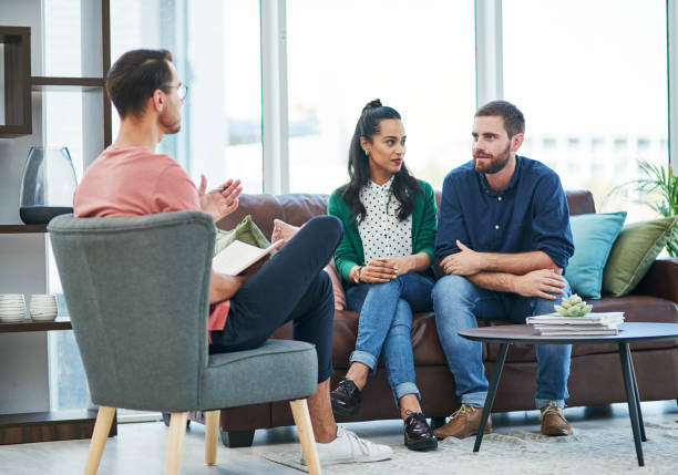 Shot of two young men and a woman having a discussion in a modern office